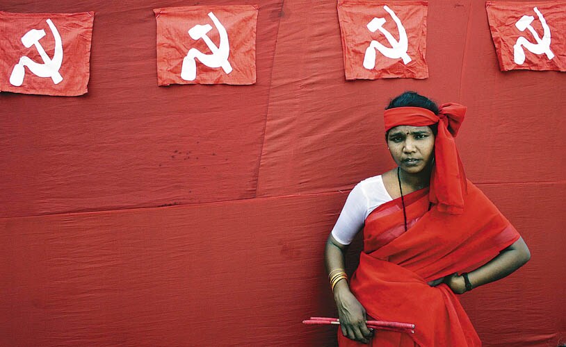 RED SIGNAL: A woman naxalite waits before her performance at a protest rally in Kolkata