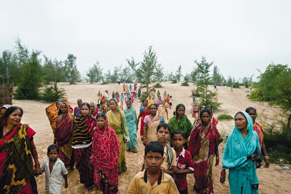 A LONG WALK HOME Women and children from Dhinkia return from a rally to prevent the police from taking down betel vines, their main source of livelihood. Most of the betel vines grow on the 2,900 acres of forest land that the Posco project will take over