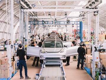 Tesla reports profit for quarter, sending shares soaring