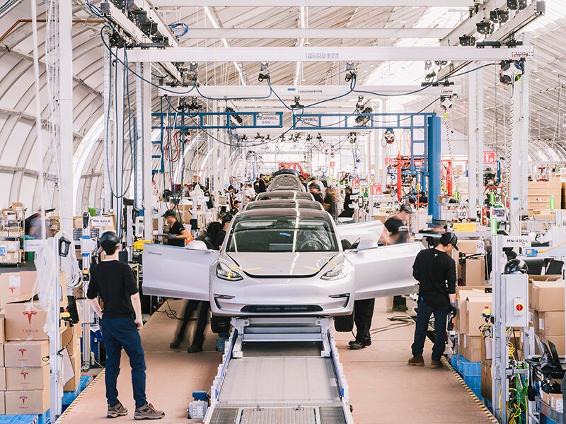 Tesla reports profit for quarter, sending shares soaring