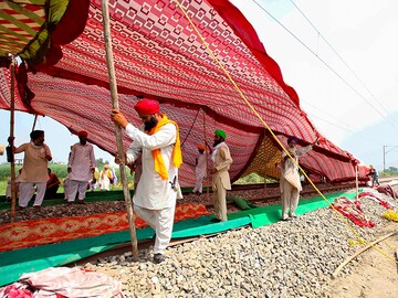 Photo of the Day: Farmers block rail tracks to protest farm bills, call for bandh