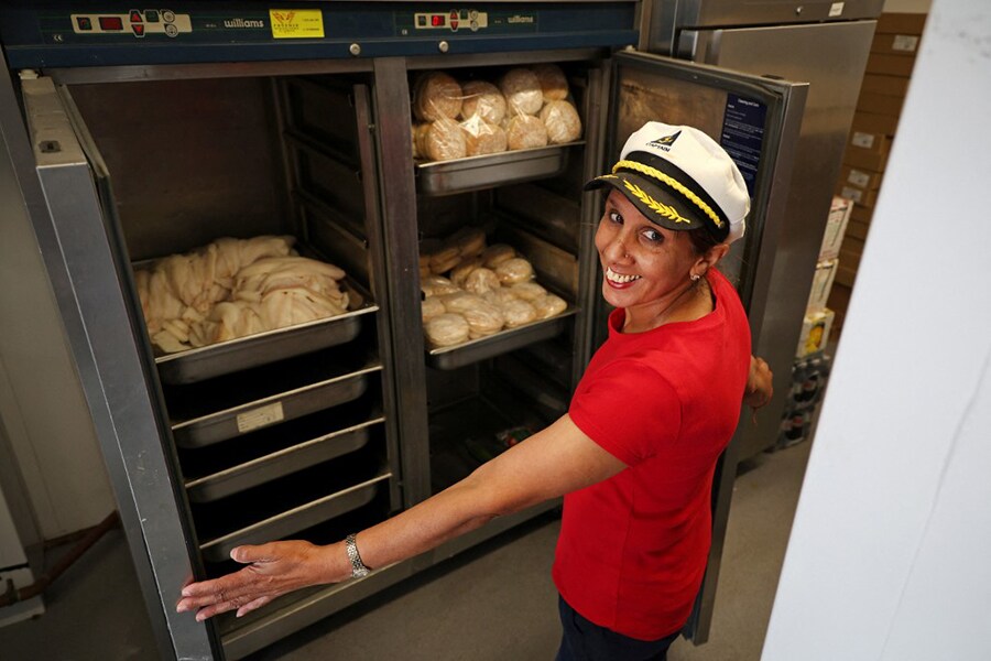 Captain's Fish and Chip shop owner Pam Sandhu, shows the contents of a freezer before opening for business in Brighton on March 25, 2022. The shelves of her large freezers are empty when they should be full of white fish ready to be dipped in batter and deep fried, then served to hungry customers with piping hot chips. 