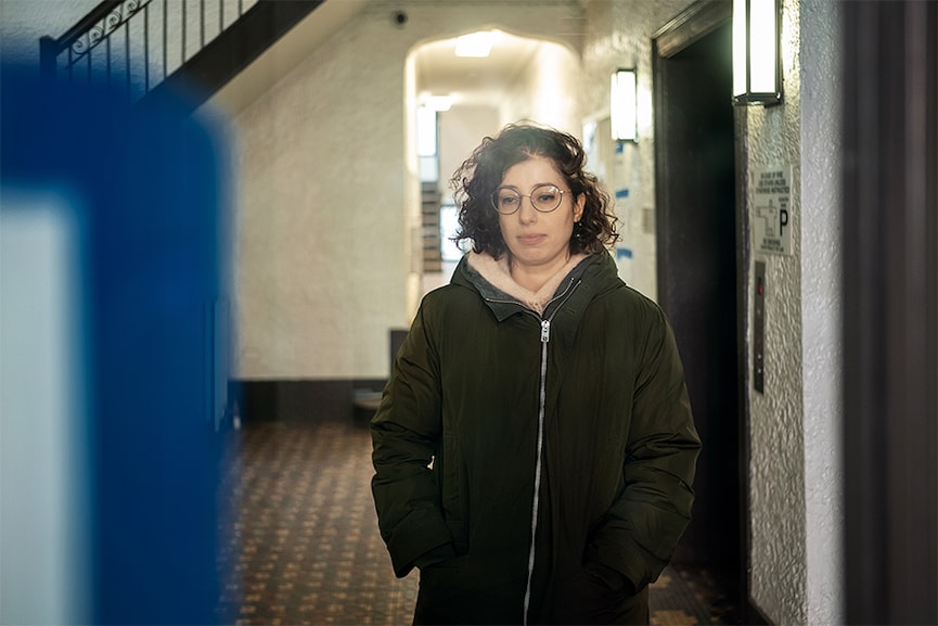 Liza Gutina in the lobby of her apartment building in Brooklyn on March 28, 2022. Her uncle, a mathematician, has chosen to stay in Kherson, a town in southern Ukraine where soldiers mostly keep to themselves, he says. (Misha Friedman/The New York Times)