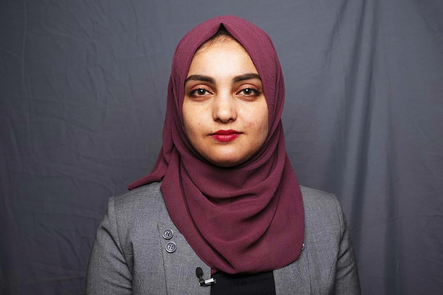 In this picture taken on August 1, 2022, TOLOnews television anchor Tahmina Usmani, 23, poses for a portrait in Kabul. Usmani is one of a few women journalists who have been able to continue working in the sector. Image: Lillian SUWANRUMPHA / AFP​
