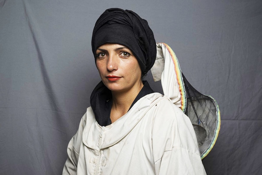 In this picture taken on August 4, 2022, businesswoman and beekeeper Ghuncha Gul Karim, 35, poses for a portrait in Herat. Karimi grew her beekeeping business to produce honey for sale after her husband left the country. Image: Lillian SUWANRUMPHA / AFP
