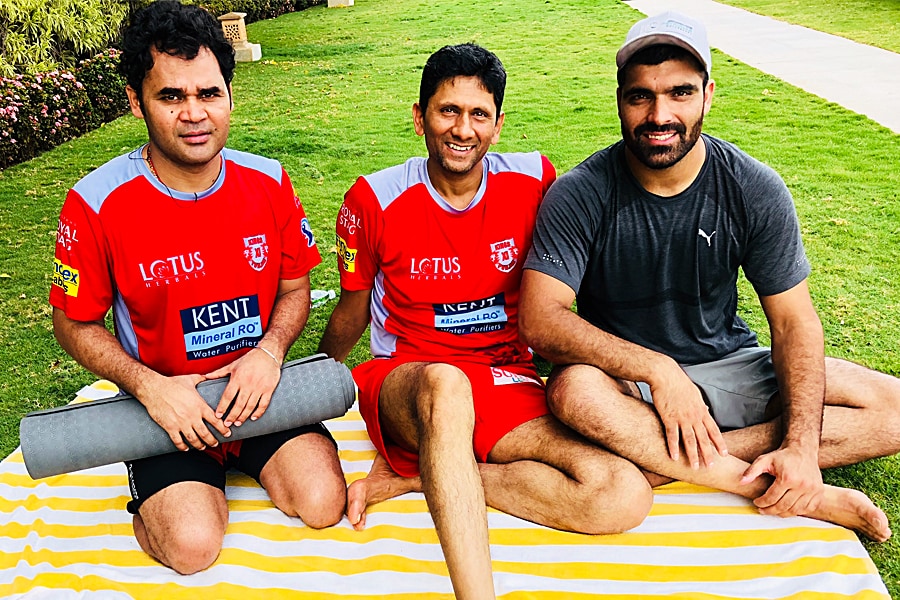 Manzoor Dar (R) with the then Punjab Kings bowling coach Venkatesh Prasad (M) and a support staff member during IPL 2018.
Image: Courtesy Manzoor Dar 