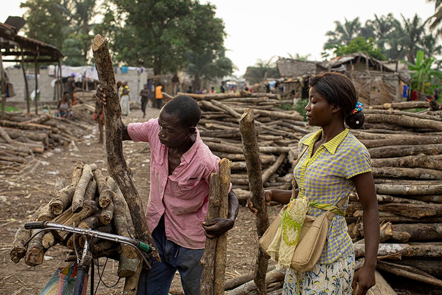 A firewood market in Mbandaka, Democratic Republic of Congo, on March 15, 2022. In the Congo River Basin, a rainforest that rivals the Amazon in importance, people who collect bundles of wood to make charcoal play a surprisingly large role in deforestation. (Ashley Gilbertson/The New York Times)