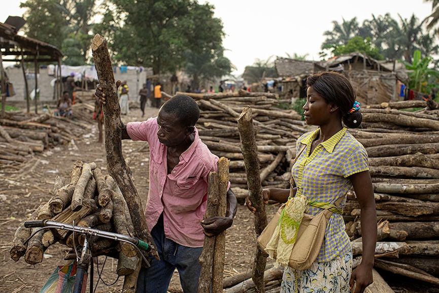 A firewood market in Mbandaka, Democratic Republic of Congo, on March 15, 2022. In the Congo River Basin, a rainforest that rivals the Amazon in importance, people who collect bundles of wood to make charcoal play a surprisingly large role in deforestation. (Ashley Gilbertson/The New York Times)