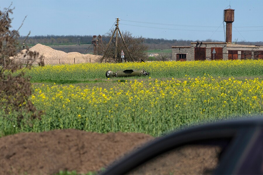 A photograph taken on April 30, 2022 shows the remain of a missile in the field on the outskirts of Berdyansk.​ (Credit: Andrey BORODULIN / AFP)


