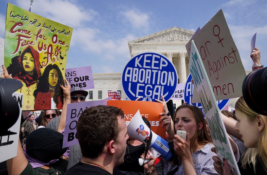 Anti-abortion and abortion-rights demonstrators mix outside the Supreme Court following a leaked draft opinion that the Supreme Court has potentially voted to overturn Roe V. Wade, in Washington, May 3, 2022. The Supreme Court on Tuesday confirmed the authenticity of a leaked draft ruling overturning the Roe v. Wade decision establishing a constitutional right to abortion but stressed that it was not final even as the disclosure triggered a political earthquake with potentially broad electoral and legal consequences. (Leigh Vogel/The New York Times)