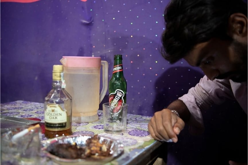 Liquor and beer bottles at a bar and restaurant in Mahottari, Nepal, April 14, 2022. Since the Indian state of Bihar banned alcohol in 2016, a small industry of bars and restaurants has sprung up just across the border in Nepal, catering to Indians of all classes seeking to quench their thirst. Image: Saumya Khandelwal/The New York Times