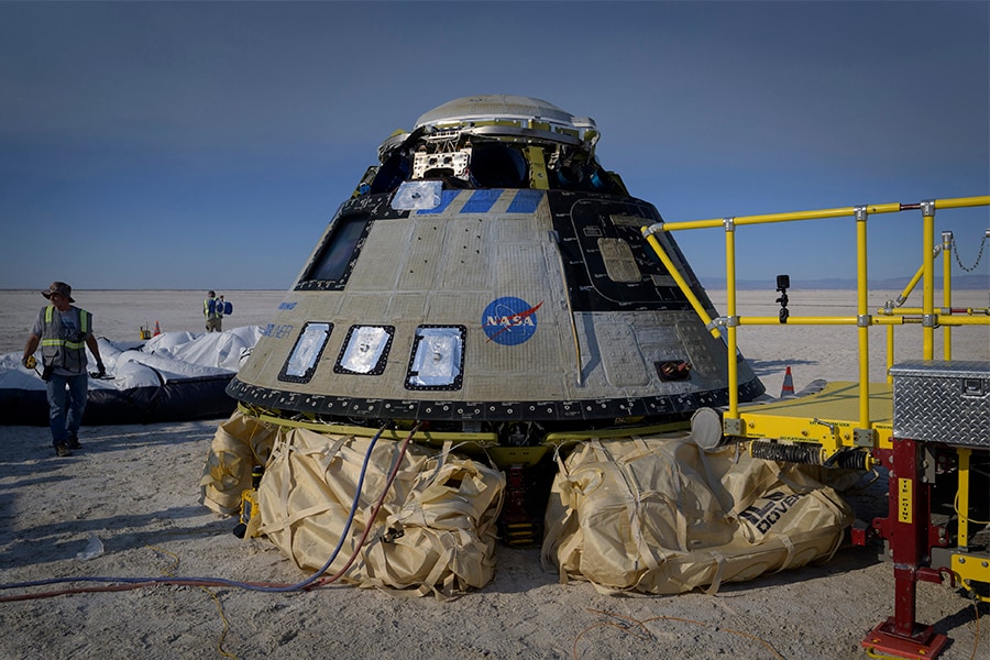 Boeing and NASA teams work around Boeing’s CST-100 Starliner spacecraft