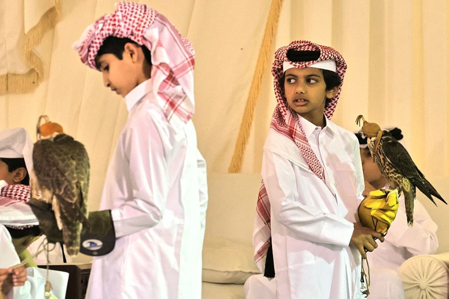 The little falconers are tested on their ability to properly remove the birds' hoods, then to successfully place them from their arm to a perch, securing their feet using a special knot.
Image: Karim Jafar / AFP 