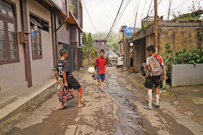 Students of government-run Chaltlang Higher Secondary School play football on their way
home, in Aizawl
Image: Mexy Xavier