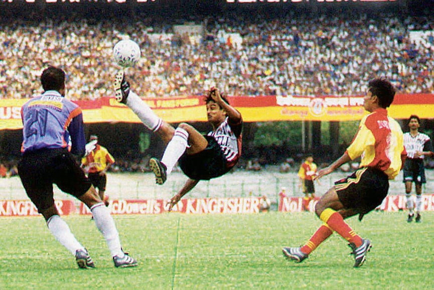 A match between Mohun Bagan and East Bengal in which Mohun Bagan’s defender Hussain Mustafi (centre) desperately clears the ball from their penalty area in a National Football League match in Calcutta in April 2001
Image: Sportasia/ AFP