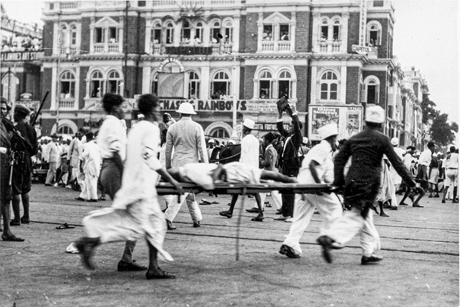 An injured protestor is taken away as Quit India movement protests in Bombay turn violent. Image: New York Times Co/Getty Images