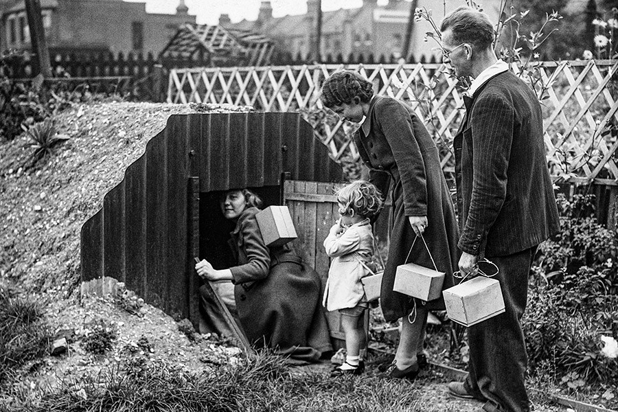 A British family stepping into a dugout air raid shelter, 1939. Image: Hulton-Deutsch Collection/Corbis/Getty Images