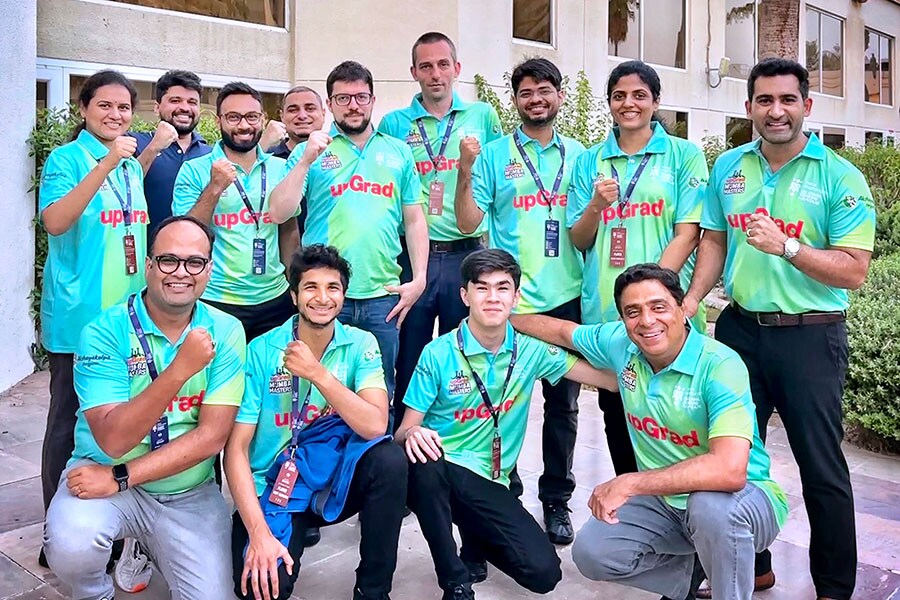 The upGrad Mumba Masters team that became the runners-up in the inaugural Global Chess League, with UMumba CEO Suhail Chandhok (standing, right) and owner Ronnie Screwvala (sitting, right) Image: Courtesy Global Chess League