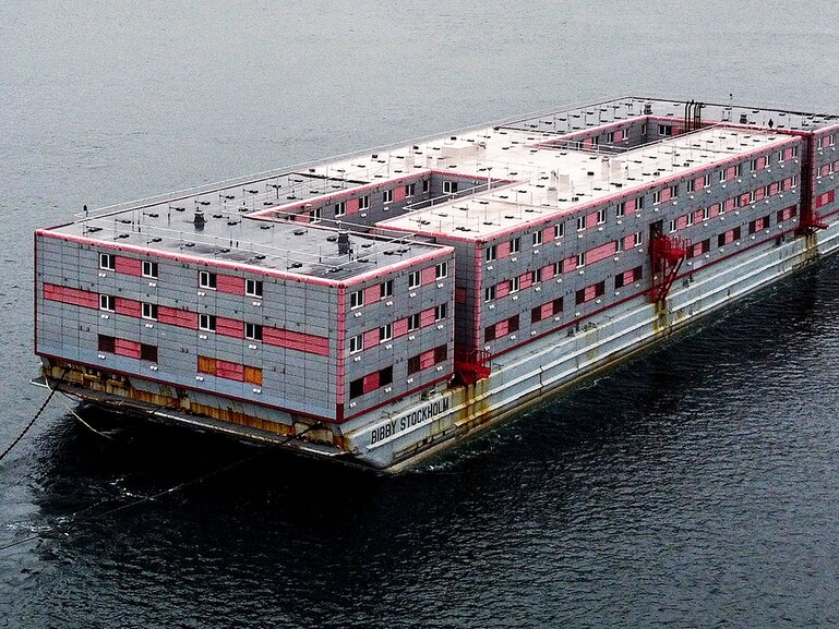 Bibby Stockholm, the 222-bedroom, three-story accommodation barge set to be used by the UK government to house up to 500 single male asylum seekers, will be positioned in Portland Port in Dorset. It is currently undergoing inspection and refurbishment in Falmouth, England, as of June 14, 2023. 