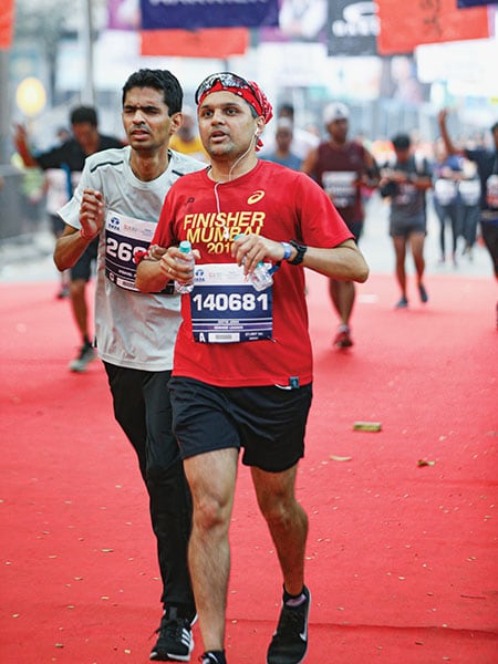 Aditya Joshi of Brookfield runs as a buddy for his visually-challenged friend Vishal Agarwal