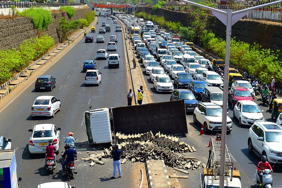 (File) An overturned truck is seen along a road after an accident along the Sarkhej-Gandhinagar highway near Ahmedabad. Image: Sam Panthaky/ AFP 
