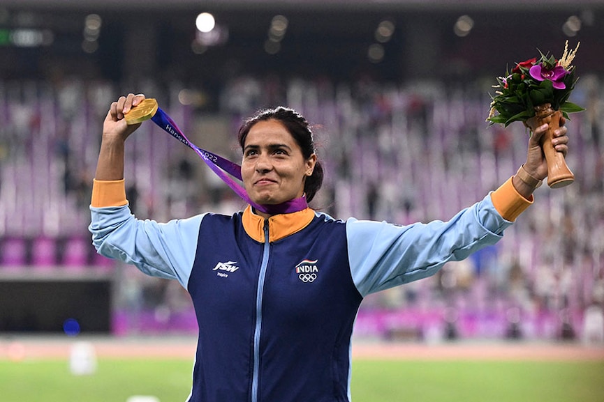 Gold medallist India's Annu Rani celebrates on the podium during the medal ceremony for the women's javelin throw final athletics event during the 2022 Asian Games in Hangzhou in China's eastern Zhejiang province on October 3, 2023. Image: William  West / AFP 