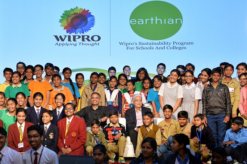 Chairman of Wipro Limited, Azim H. Premji, (C-R) and Chief Sustainability Officer of the company, Anurag Behar (C-L) pose for photographs after presenting the Annual 