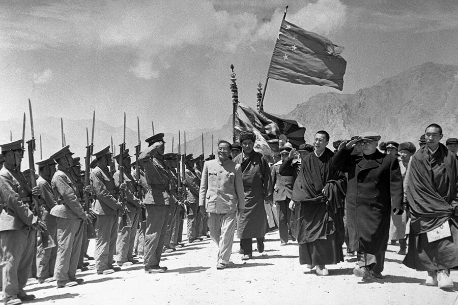 Chen Yi, vice premier of China (saluting, second from right) visits Tibet to organise Tibet’s inclusion in the Communist Chinese framework. Reviewing local troops with Yi are the Dalai Lama, spiritual leader, and Panchen Lama, May 1956. Image: Bettmann/Getty