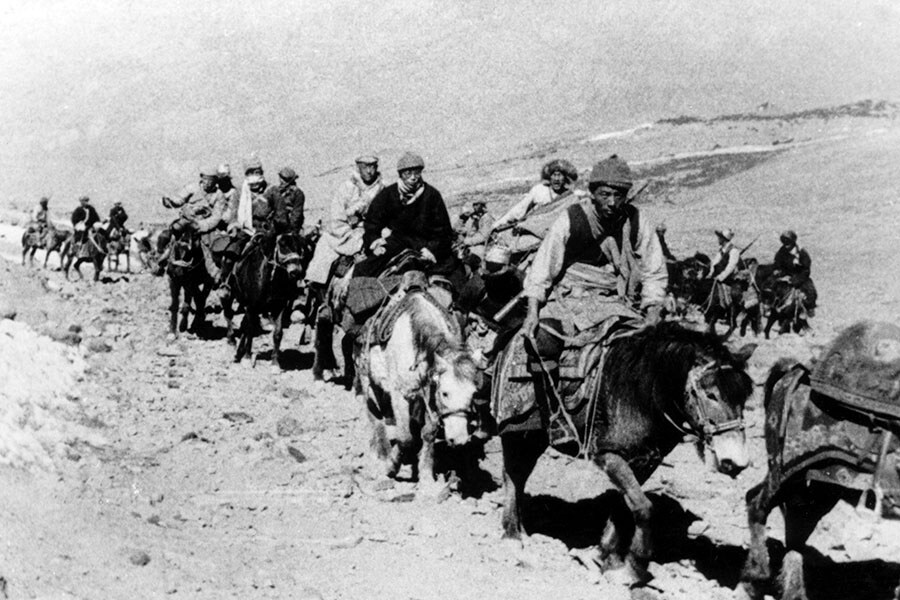 Tenzin Gyatso, the 14th Dalai Lama (centre, on a white horse) escapes from Tibet to India, on February 1, 1959.  Image: Universal Images Group via Getty Images