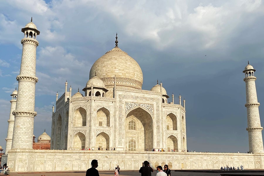 As the first light of dawn caresses the sky, the Taj Mahal bathes in golden hues, a timeless embrace of sunlight's kiss. Image: Veidehi Gite 