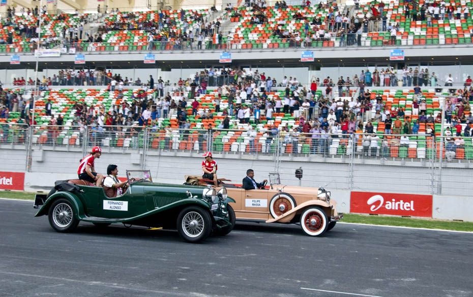 Ferrari's Felipe Massa & Fernando Alonso get introduced to the crowds in vintage cars. A few