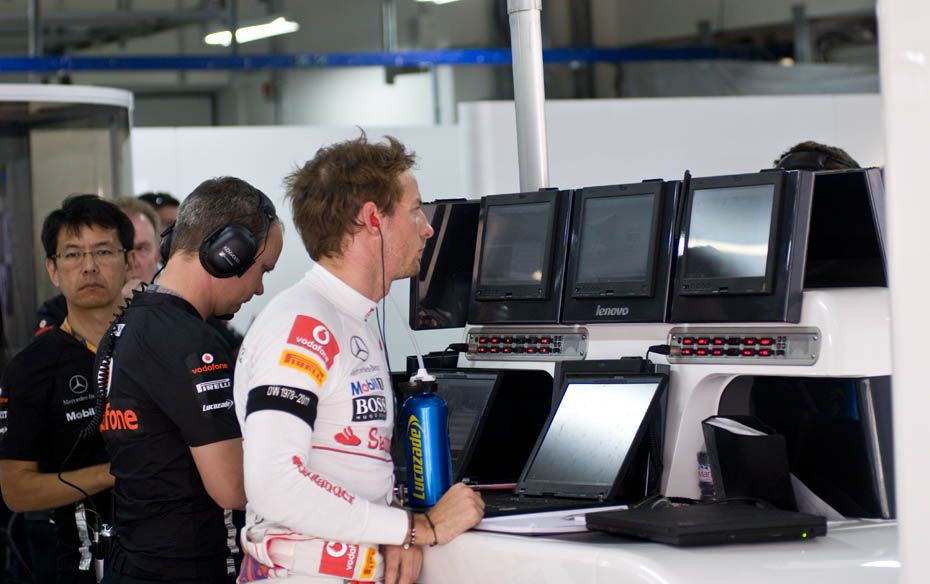 Jenson Button of McLaren-Mercedes reviews his performance after the practice session on October 29. 