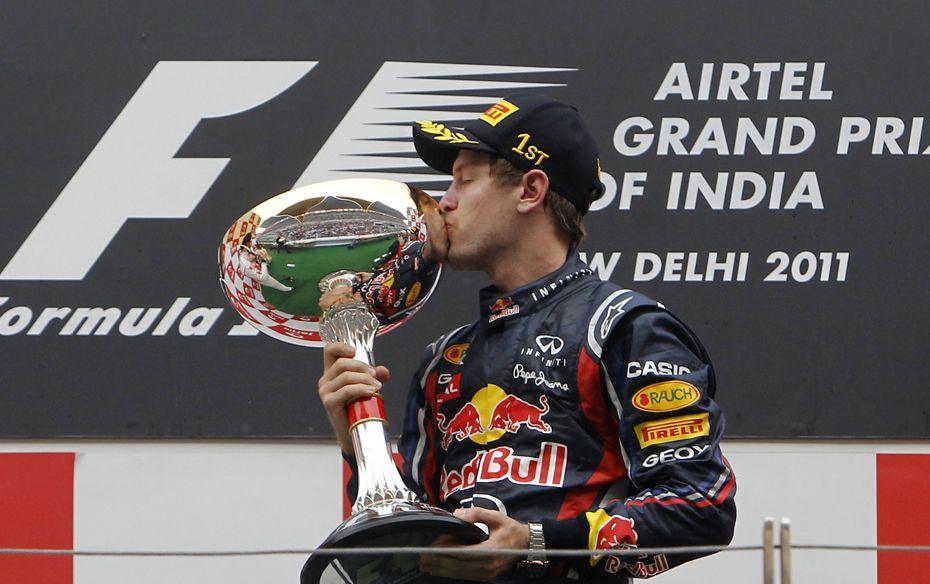 Red Bull Formula One driver Sebastian Vettel of Germany kisses his trophy after winning the first In