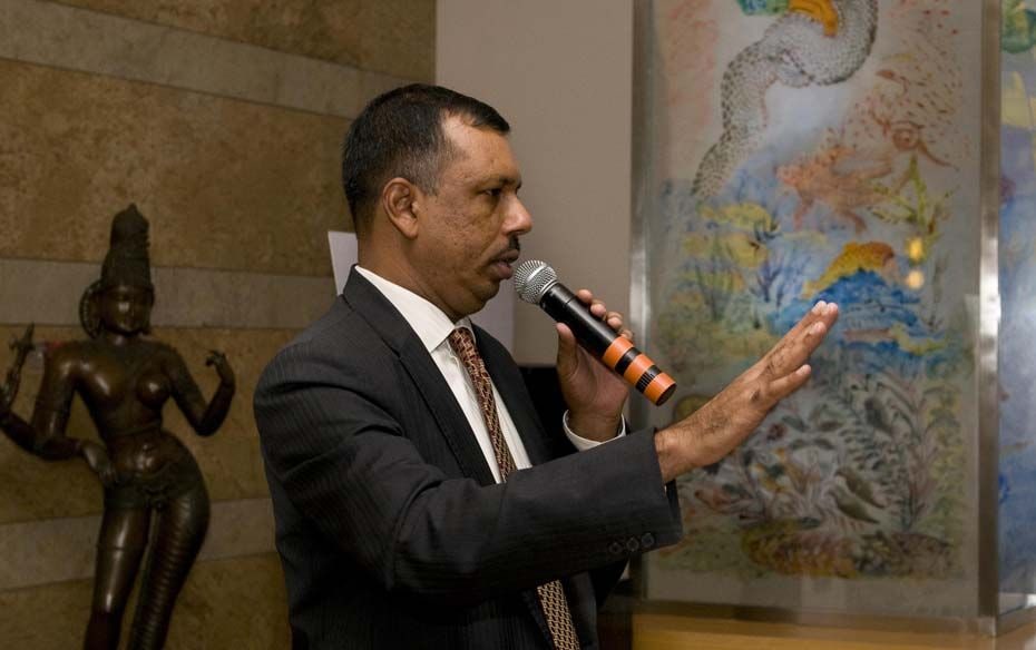 K. Ramkumar, ICICI, CHRO standing next to an art work by Nalani Malani