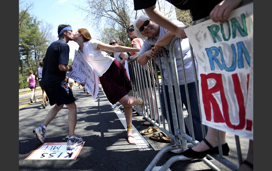 Wellesley College Sophomore Mayrah Udvardi, of Canberra, Australia,  gives a runner a kiss along the