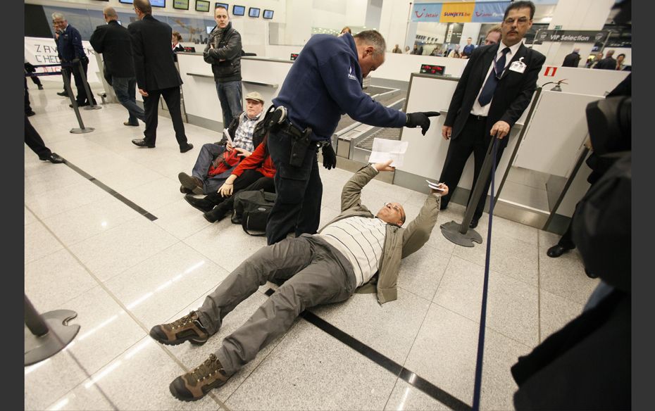 A would-be passenger lays on the ground as around 100 pro-Palestinian activists stage a protest at B