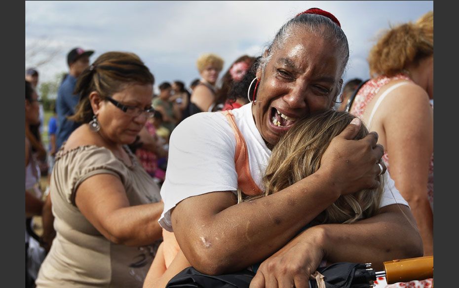 Denise Paba, who lost her six-year-old niece Veronica Moser, cries during a memorial for victims beh