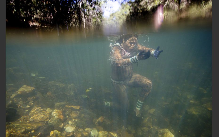 A Kayapo Indian takes a dip in the Sao Miguel River during the ‘Meeting of Traditional Culture