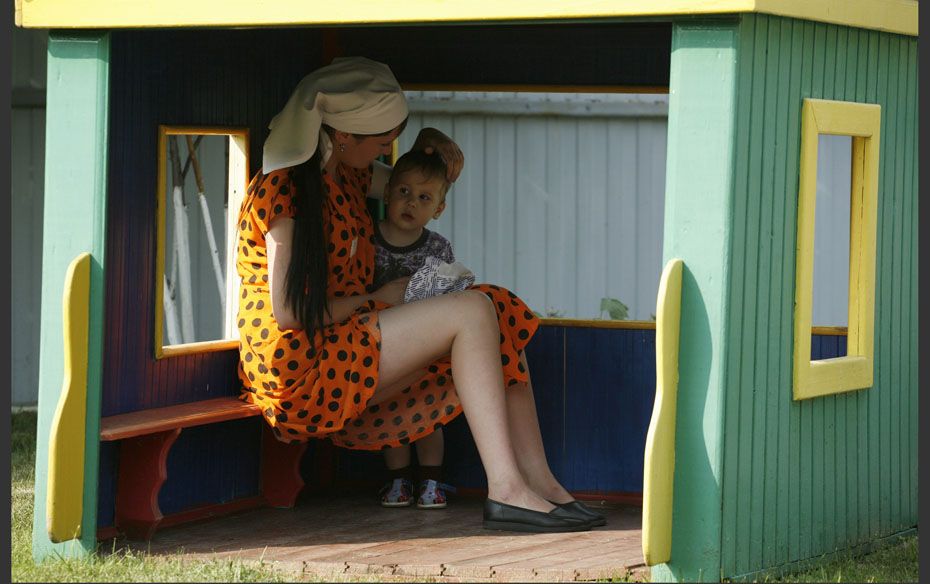 An inmate spends time with her child at the courtyard of a “children’s home” locat