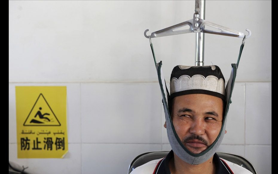 An ethnic Uighur resident receives traditional Chinese medical treatment to cure cervical spondylosi