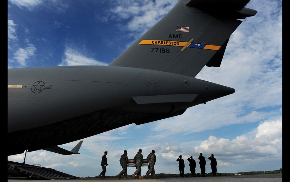 US army soldiers carry the flag-draped transfer case containing the remains of Major Thomas E Kenned