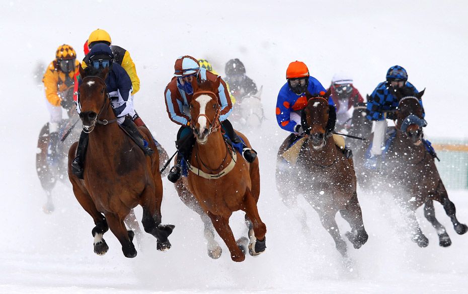 Two horses tear ahead of the pack into the second turn of the Grand Prix Prestige race at the White 