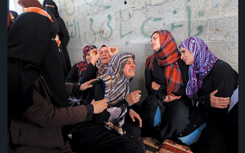 Relatives of a 12-year-old Palestinian boy killed in an Israeli air raid on the northern Gaza strip 