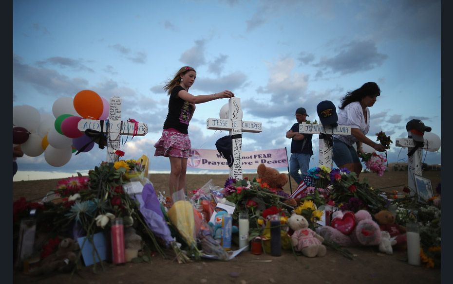 Thousands continue to visit the makeshift memorial for the 12 movie goers who were killed in a shoot