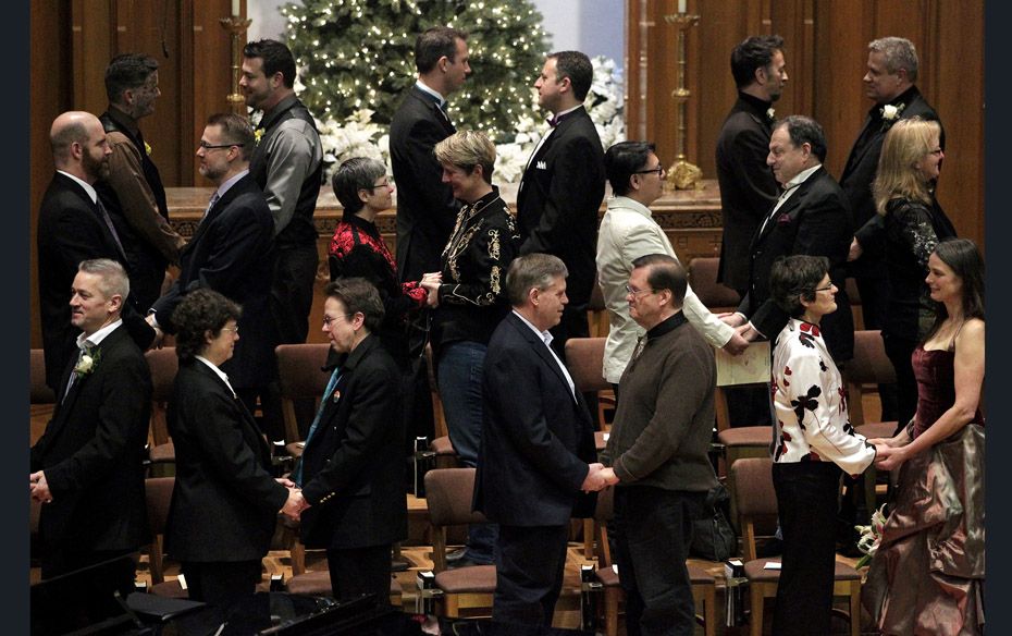 Same-sex couples take their vows during a group wedding at the First Baptist Church at Seattle in Wa