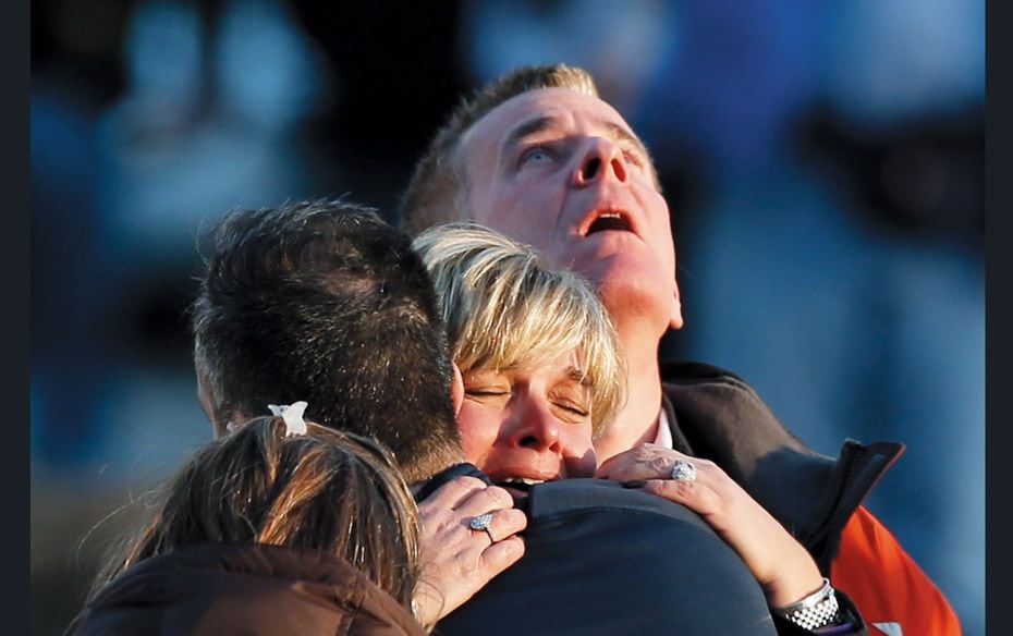 Family members and friends grieve for the shooting victims at Sandy Hook Elementary School in Newtow