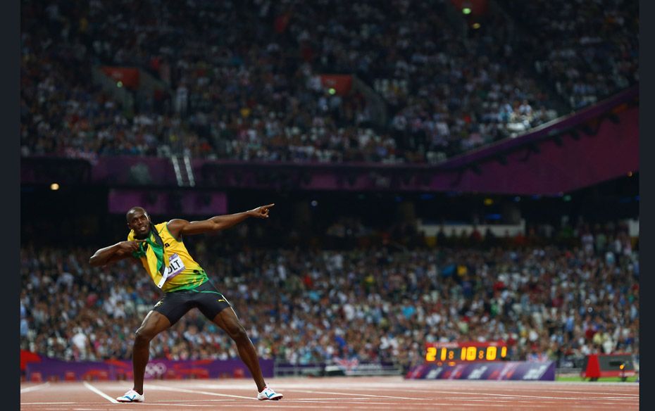 Usain Bolt of Jamaica celebrates after ascending to sporting immortality, winning the 100m, 200m, an