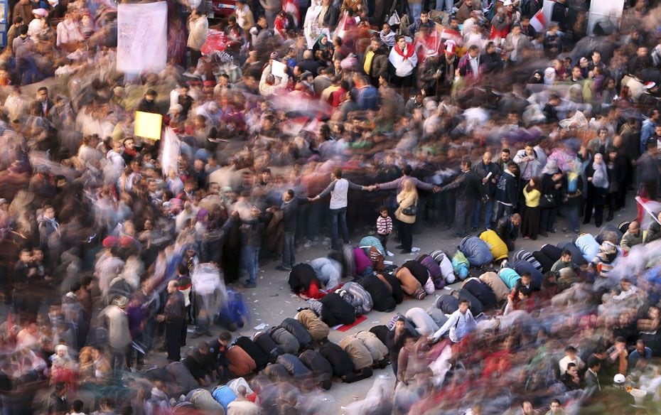 Demonstrators pray at Tahrir square during a protest marking the first anniversary of Egypt's up