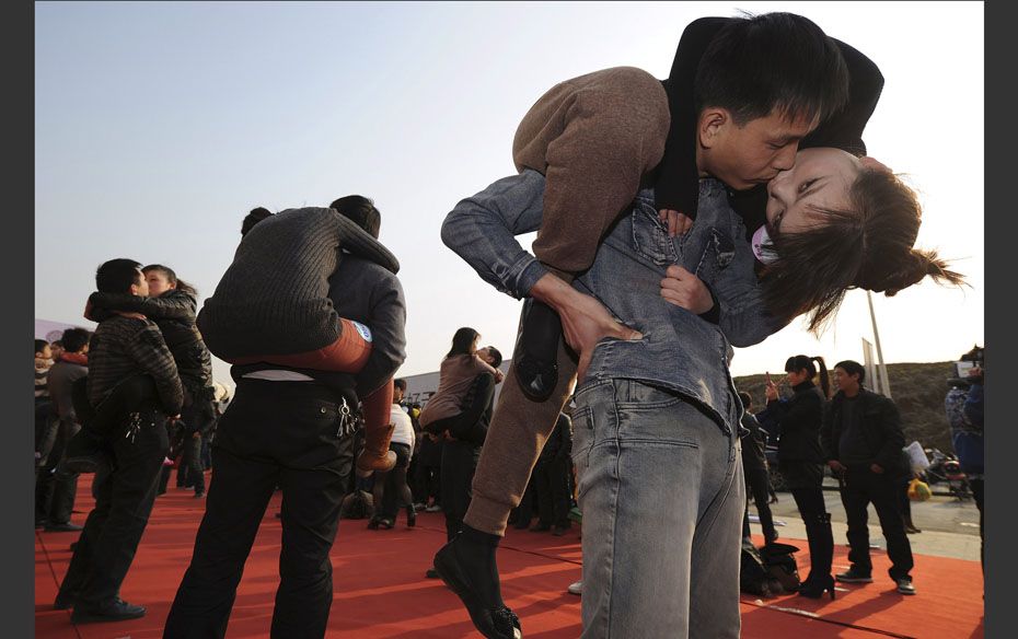 Couples participate in a kissing contest in China. A total of 63 couples took part in the contest in