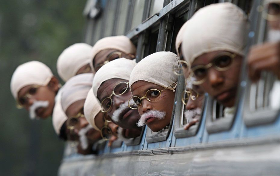 Children dressed as Mahatma Gandhi arrive on a bus to take part in a peace march in Kolkata    